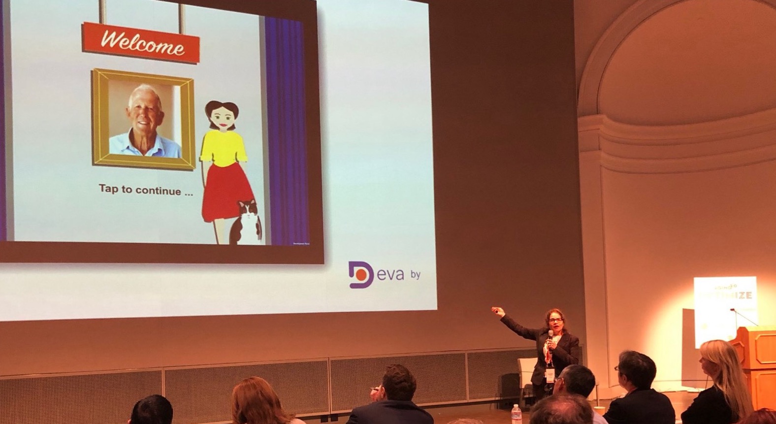 Mandy Salomon presenting the DevaWorld welcome screen to a conference audience