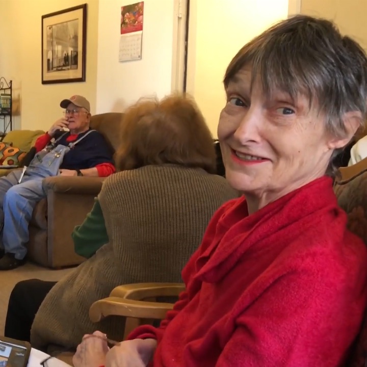 A resident smiling during a Mentia visit